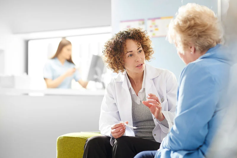Pharmacist seated consultation with patient